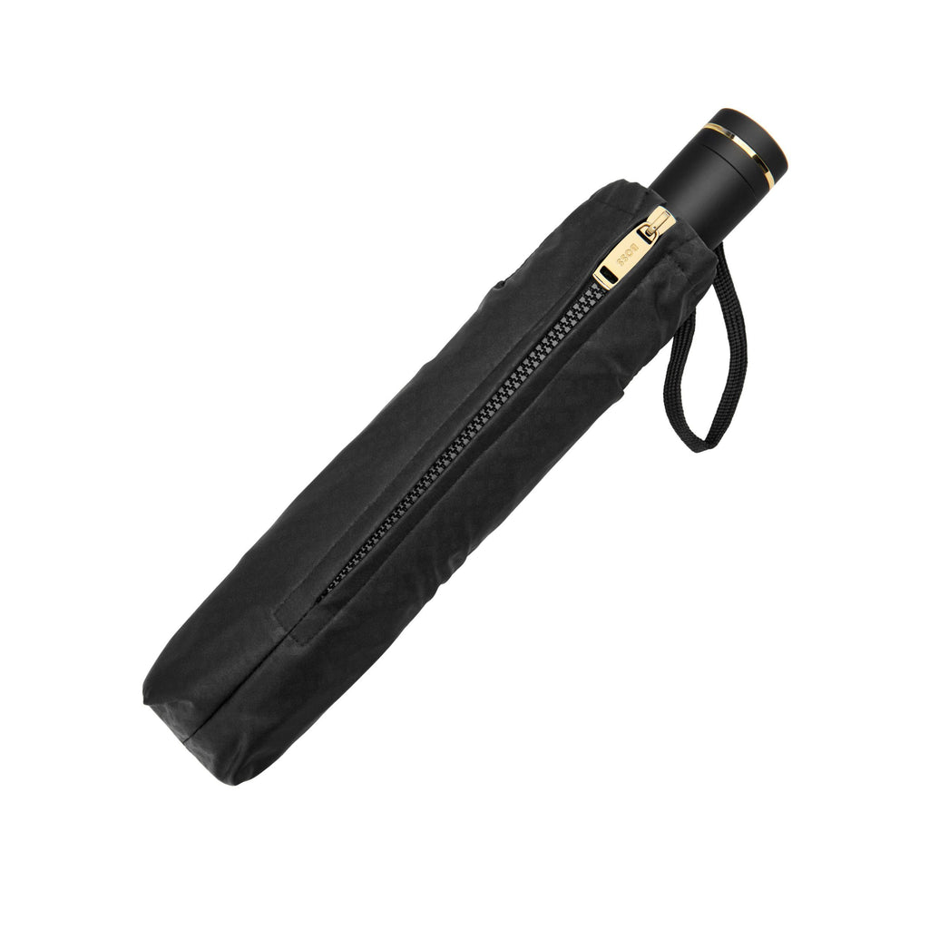 BOSS black umbrella with gold accents on a white background